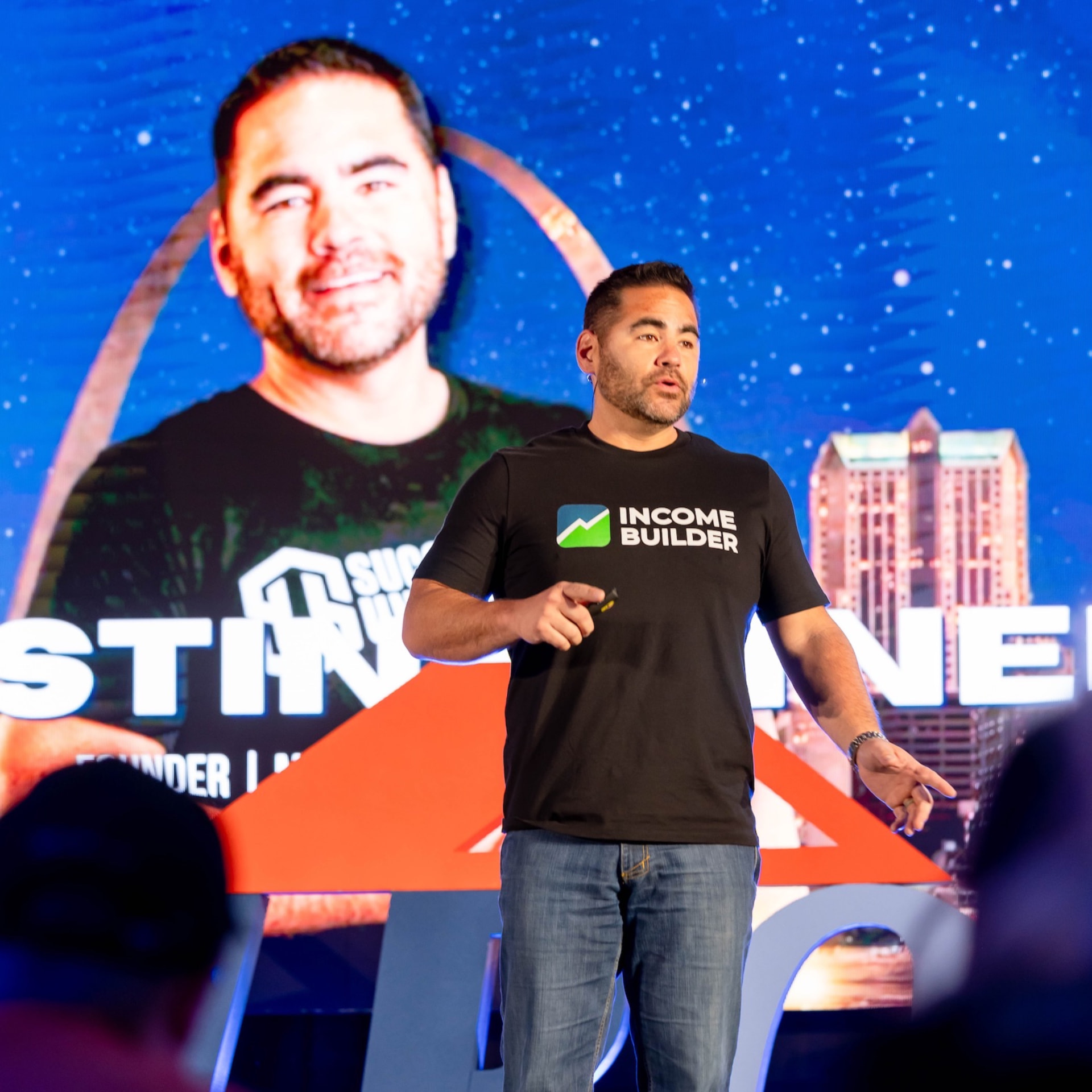 Dustin Heiner speaking on stage at a real estate investing event
